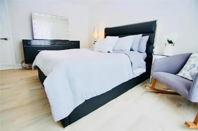 a bed sitting in a bedroom next to a couch