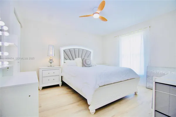 a bedroom with a bed and a chandelier