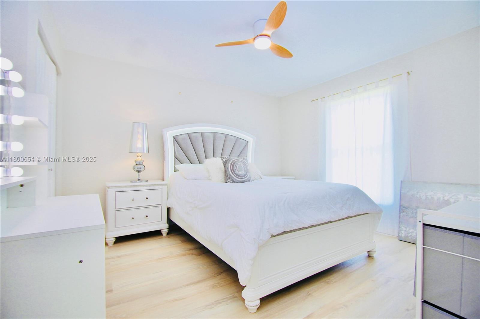 244 Northwest 6th Avenue, Unit 244 Delray Beach, FL 33444 - Photo 22 of 35 a bedroom with a bed and a chandelier