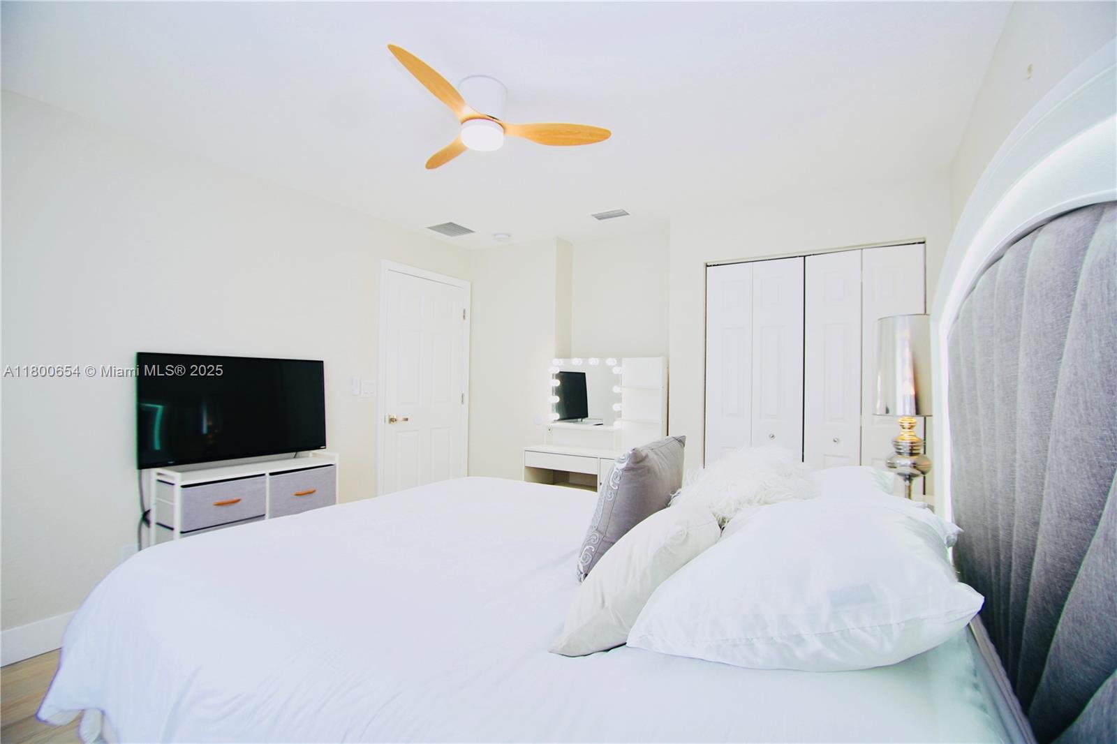 244 Northwest 6th Avenue, Unit 244 Delray Beach, FL 33444 - Photo 26 of 35 a bedroom with a bed and a flat screen tv