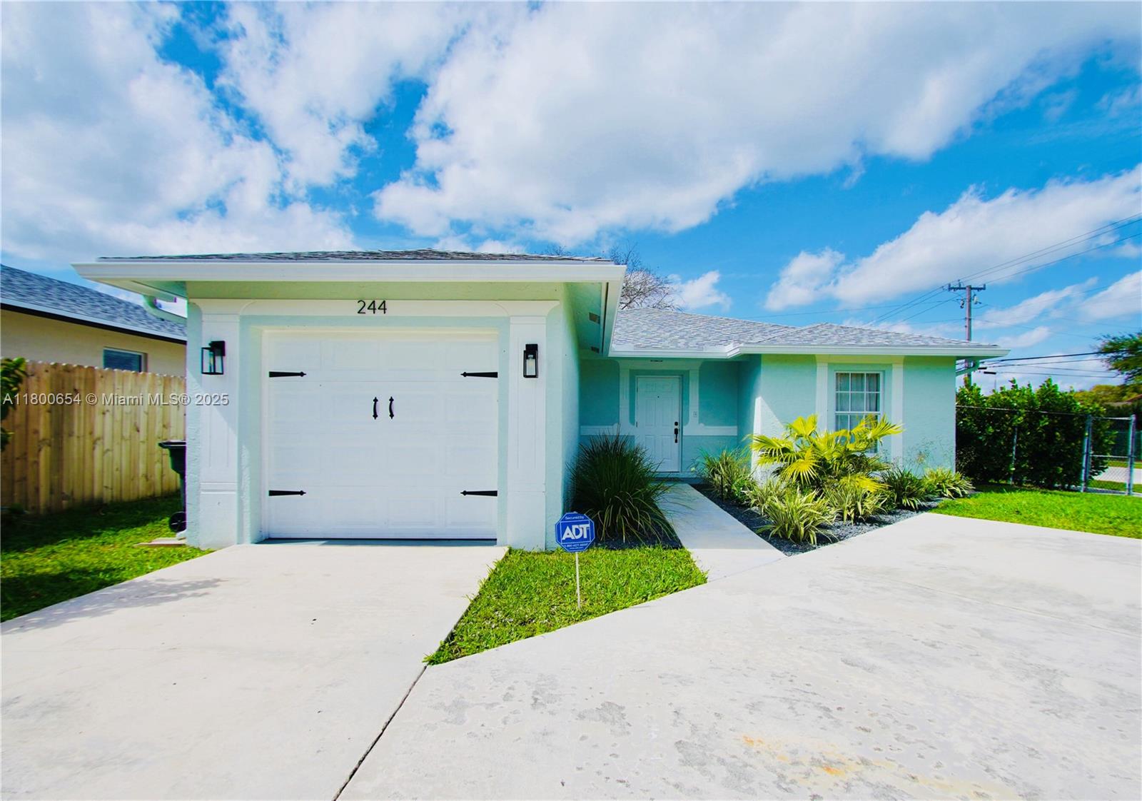 244 Northwest 6th Avenue, Unit 244 Delray Beach, FL 33444 - Photo 35 of 35 a front view of a house with garden