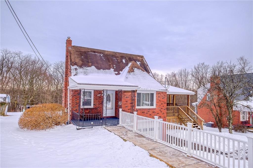 front view of a house with a wooden fence