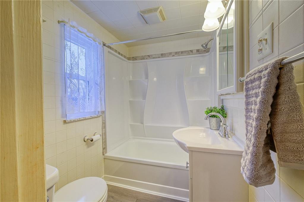 33 Kennedy Lane McKees Rocks, PA 15136 - Photo 14 of 19 a bathroom with a granite countertop bathtub shower sink and toilet