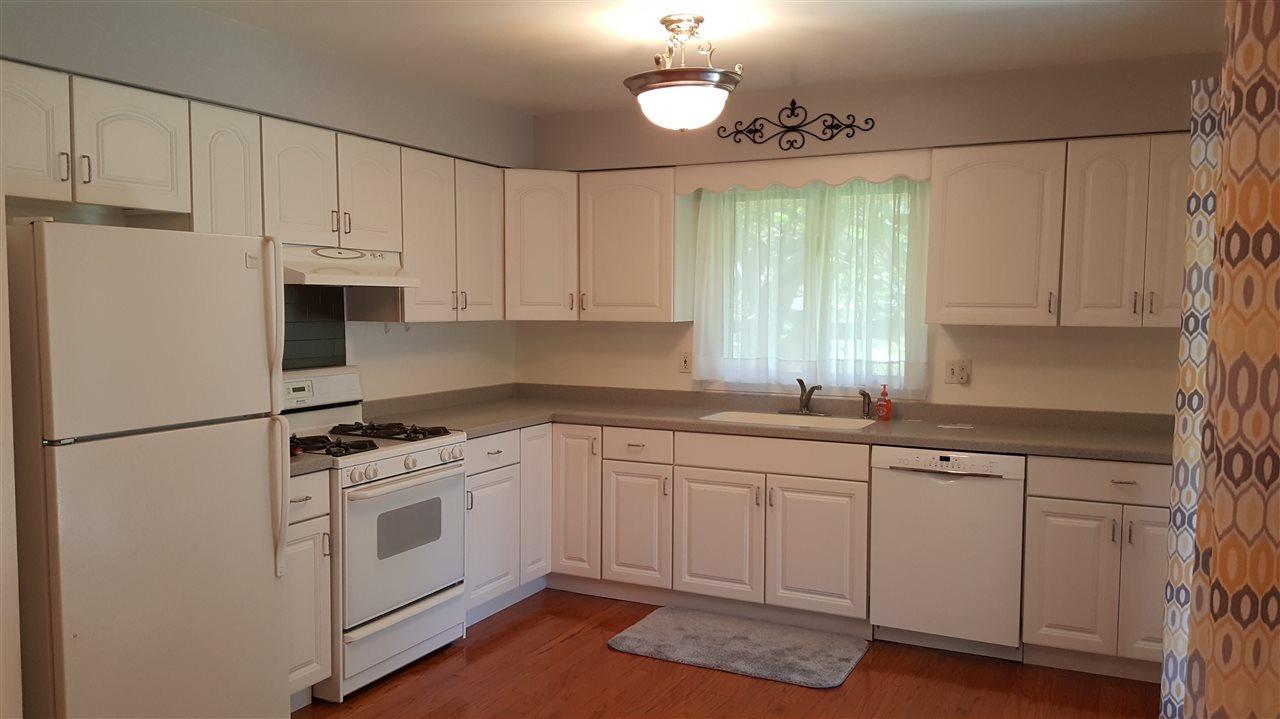 414 Rebecca Road Belvidere, IL 61008 - Photo 2 of 22 a kitchen with white cabinets and white appliances