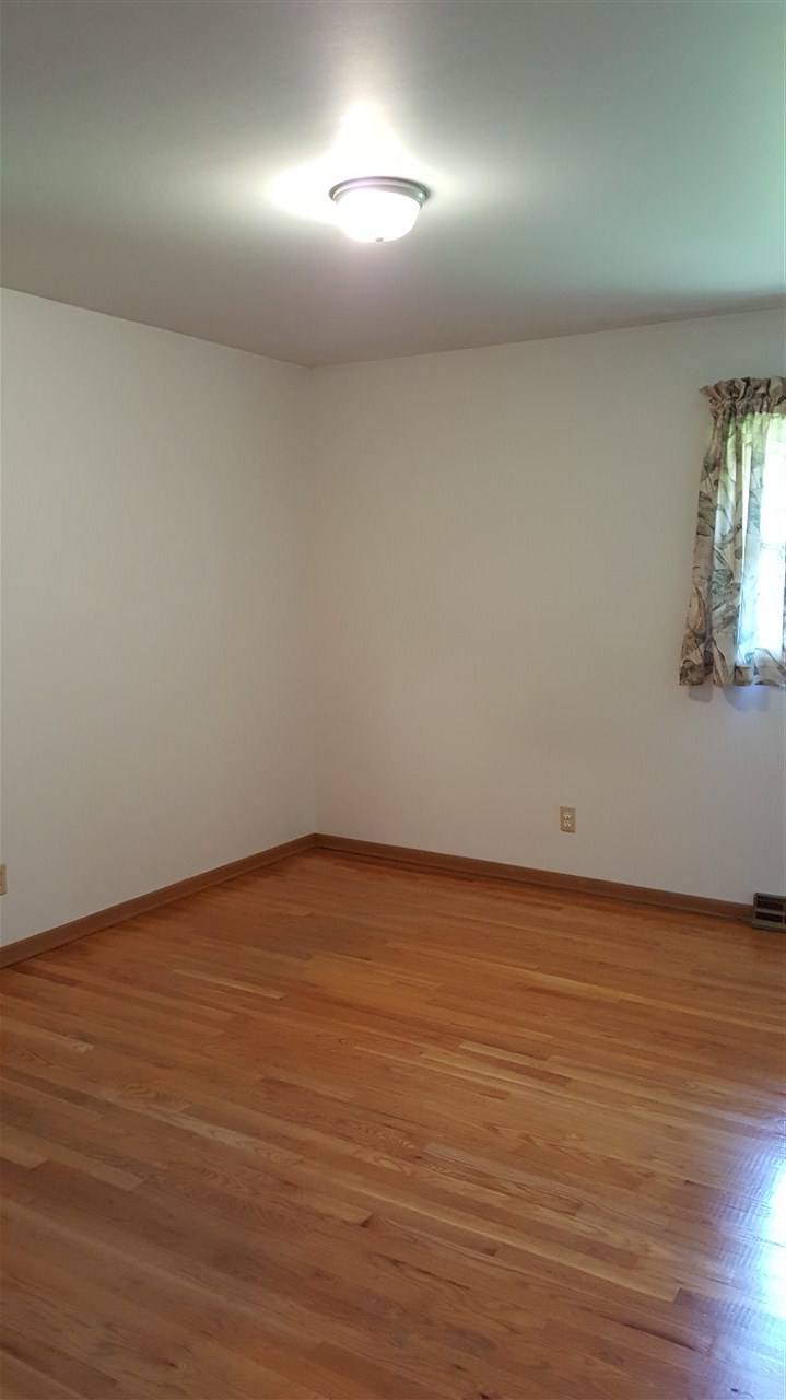 414 Rebecca Road Belvidere, IL 61008 - Photo 8 of 22 an empty room with wooden floor and windows