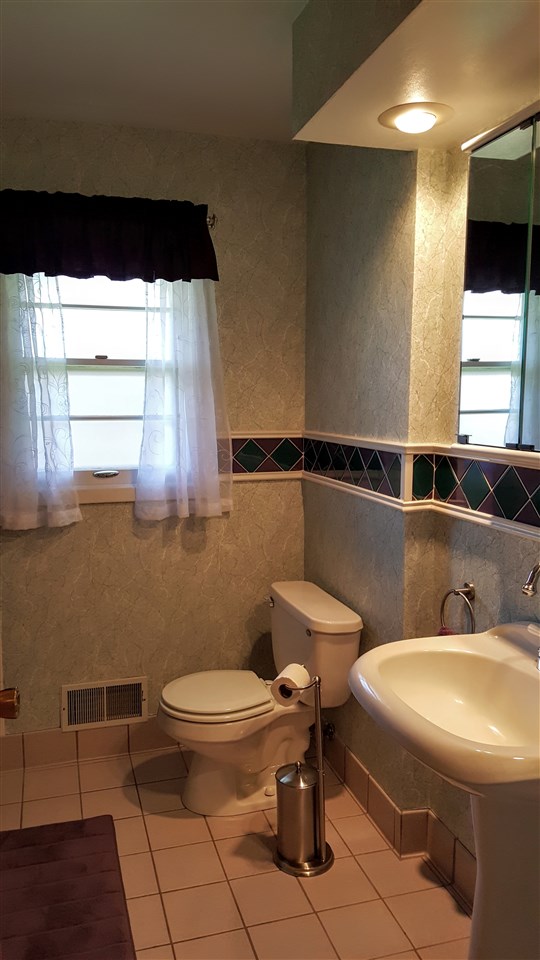 414 Rebecca Road Belvidere, IL 61008 - Photo 9 of 22 a bathroom with a sink a toilet and a mirror