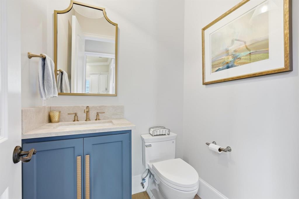 476 Hidden Valley Lane Coppell, TX 75019 - Photo 13 of 40 a bathroom with a toilet sink and mirror