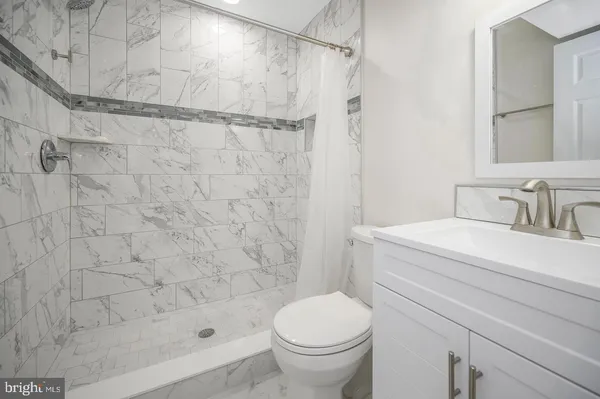 a bathroom with a shower and a toilet