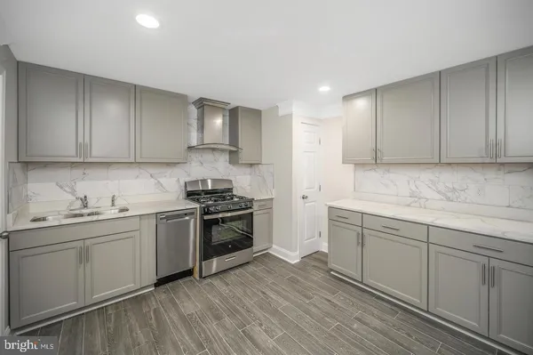 a kitchen with stainless steel appliances granite countertop a sink and cabinets