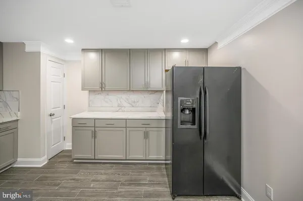 a kitchen with stainless steel appliances granite countertop a refrigerator and a stove