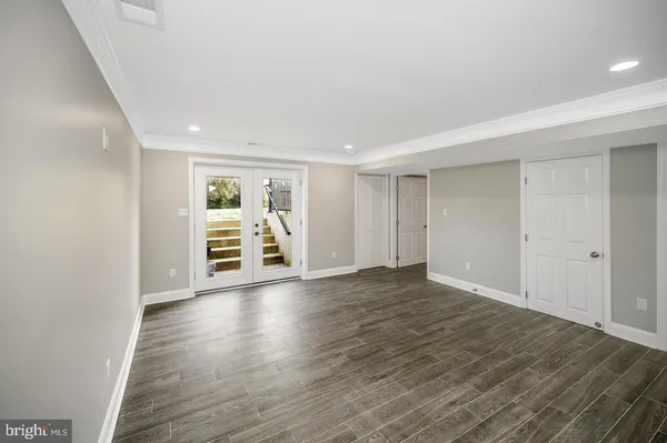 a view of empty room with wooden floor