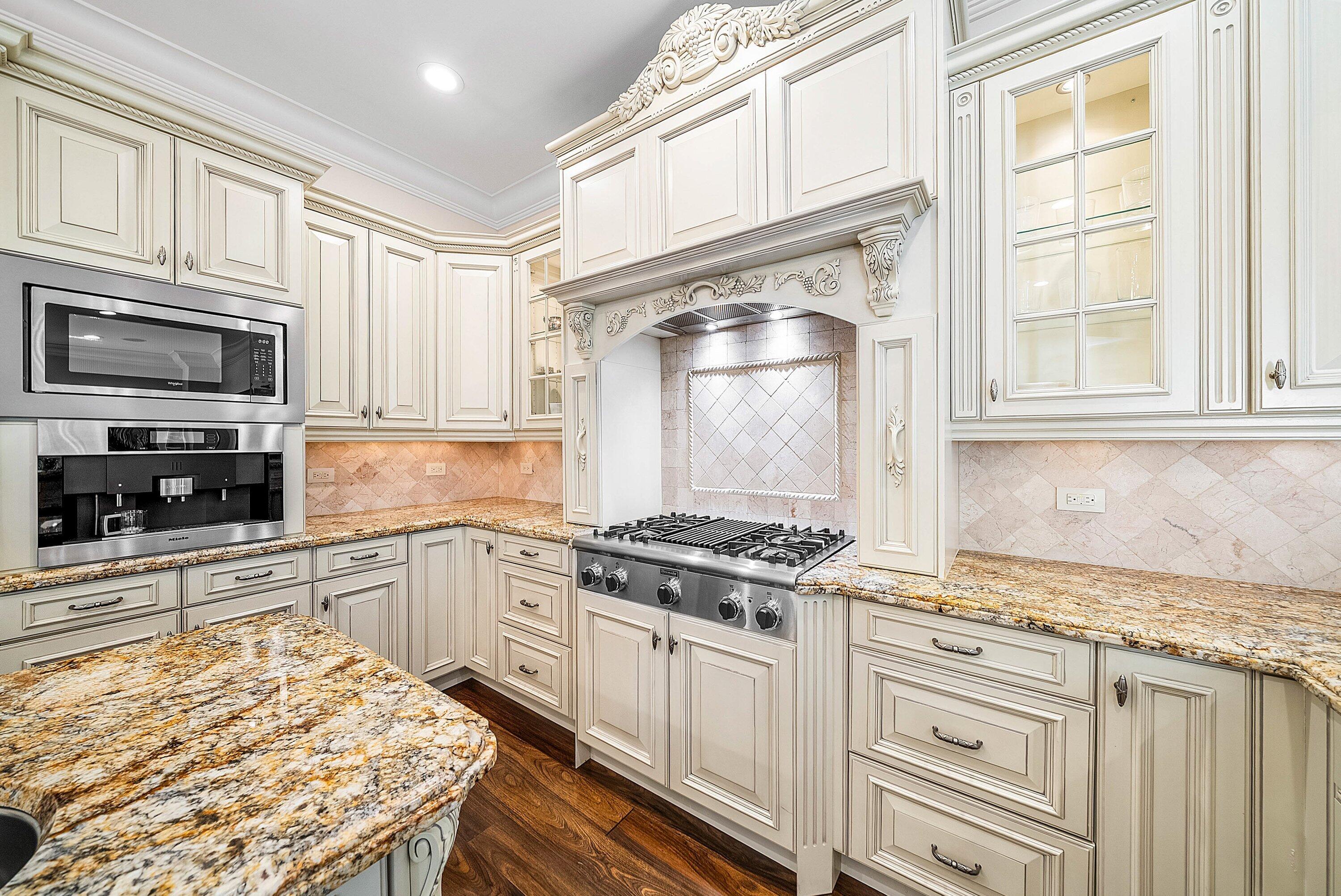398 Northeast 7th Street Boca Raton, FL 33432 - Photo 22 of 74 a kitchen with stainless steel appliances granite countertop a stove and a sink