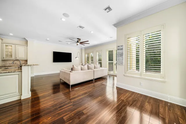 a bathroom with a granite countertop sink a toilet and shower
