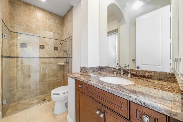 a spacious bathroom with a double vanity sink a mirror and a bathtub