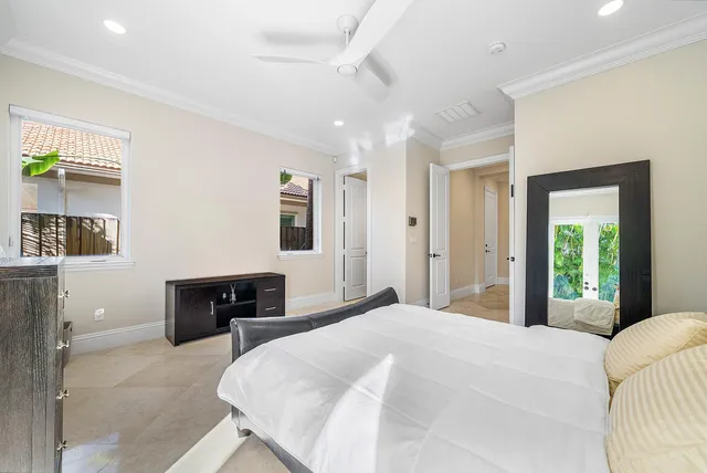 a bedroom with a bed and a large window