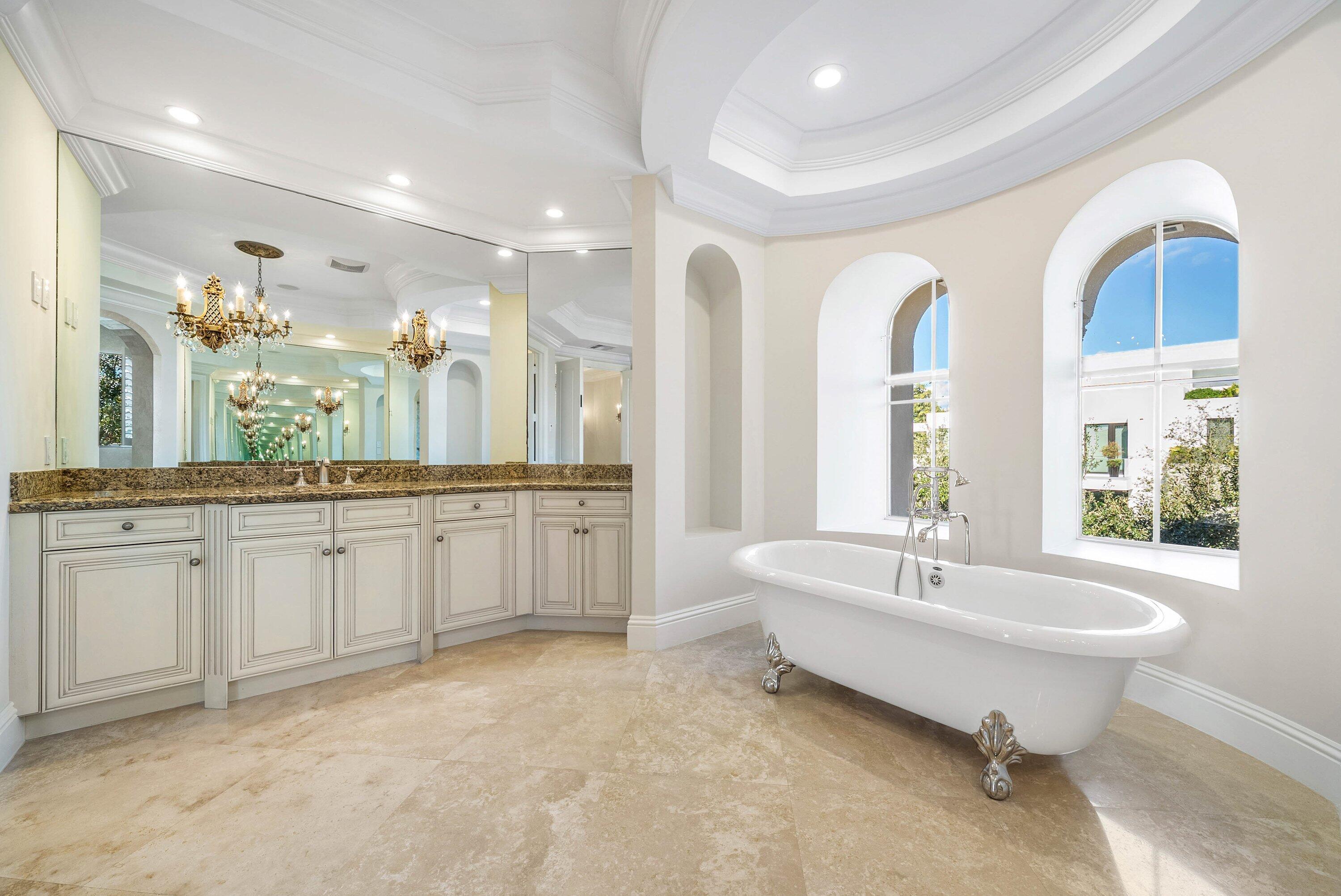 398 Northeast 7th Street Boca Raton, FL 33432 - Photo 58 of 74 a spacious bathroom with a double vanity sink a mirror and a bathtub