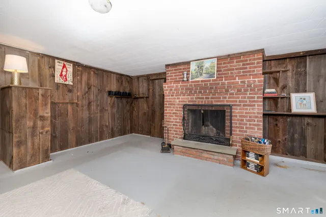 a view of a livingroom with a fireplace and a window