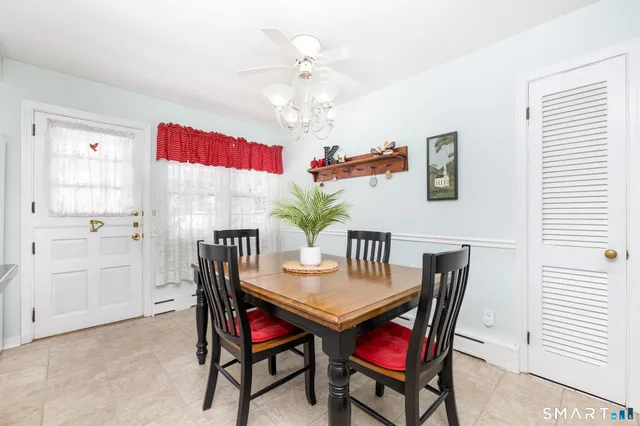a view of a dining room with furniture and chandelier