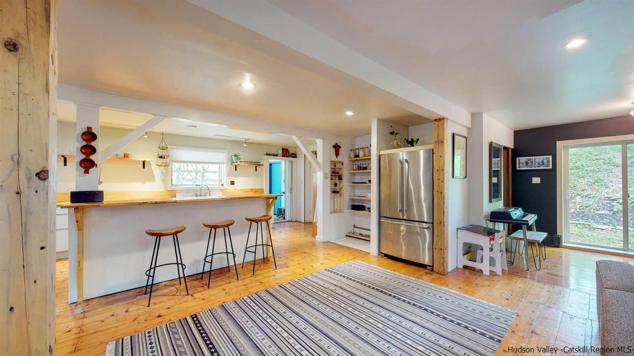 209-211 Fish Creek Road Saugerties, NY 12477 - Photo 12 of 35 a living room with furniture a large window and wooden floor