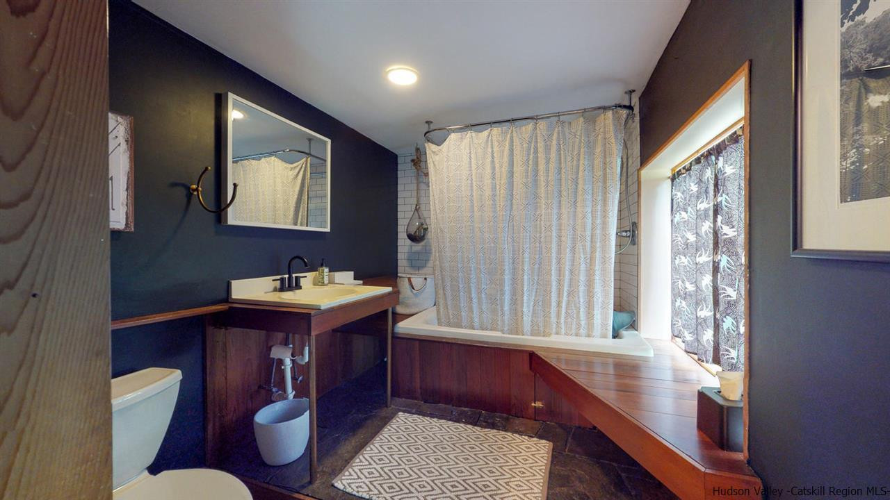209-211 Fish Creek Road Saugerties, NY 12477 - Photo 13 of 35 a bathroom with a sink mirror vanity and toilet