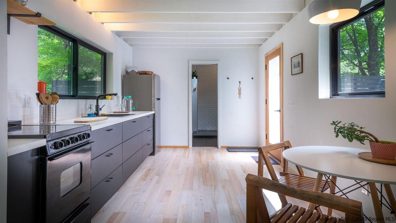 209-211 Fish Creek Road Saugerties, NY 12477 - Photo 31 of 35 a kitchen with a table chairs and a wooden floor