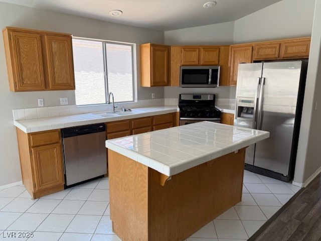 951 Country Back Road Las Vegas, NV 89123 - Photo 9 of 20 Kitchen with stainless steel appliances, a sink, tile countertops, and a kitchen island