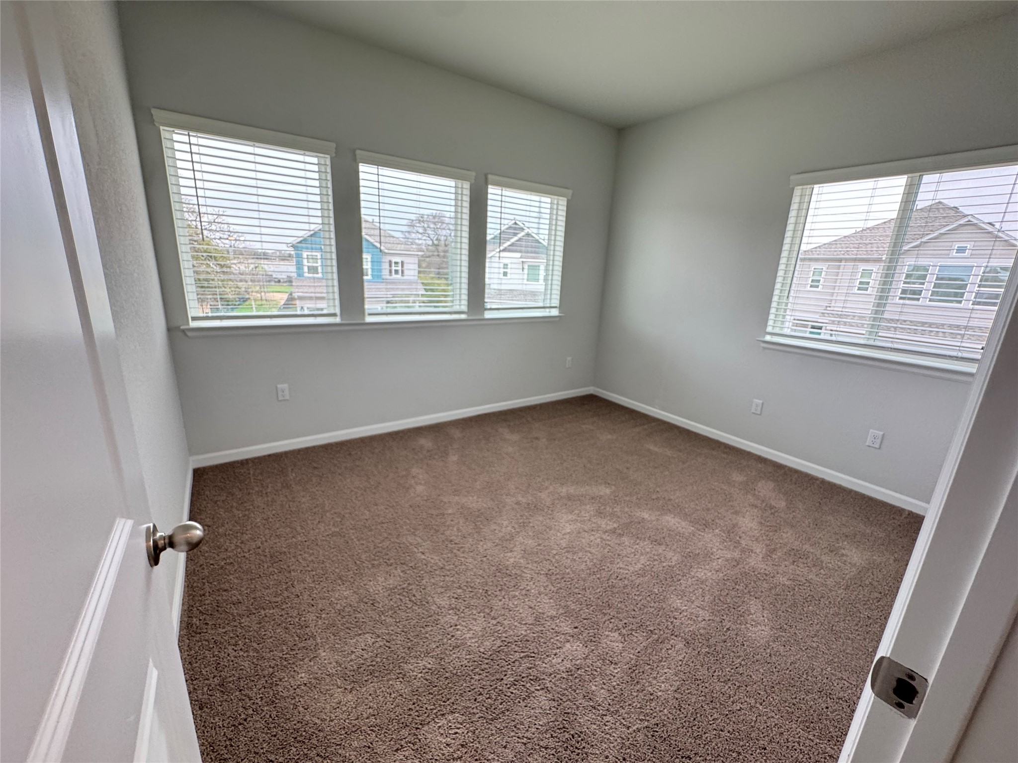 3000 Chisholm Trail Road, Unit 103 Round Rock, TX 78681 - Photo 22 of 32 Bedroom 2 featuring dark colored carpet and baseboards