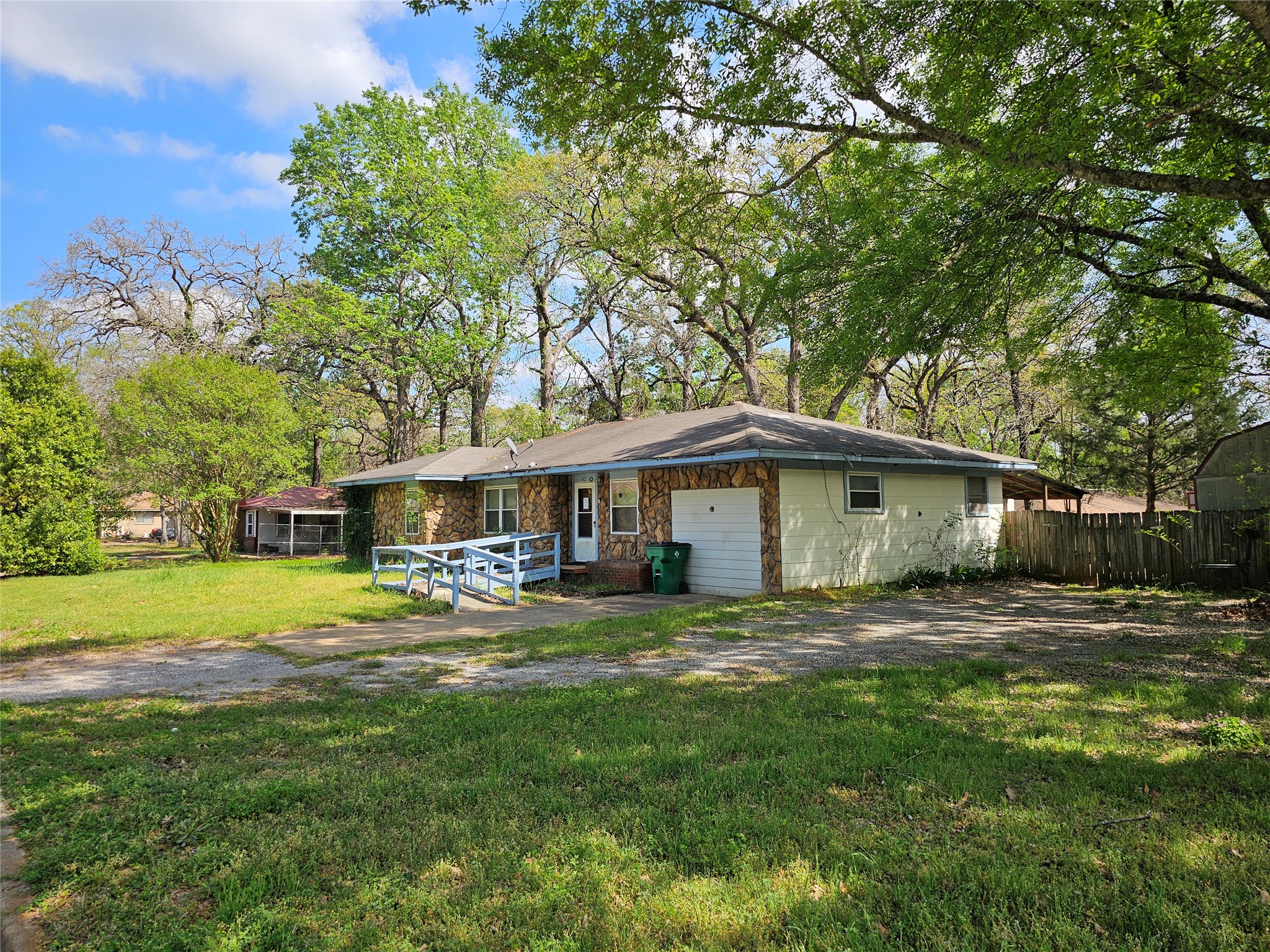 216 Westwood Road Palestine, TX 75803 - Photo 2 of 23 a yellow house in middle of the forest