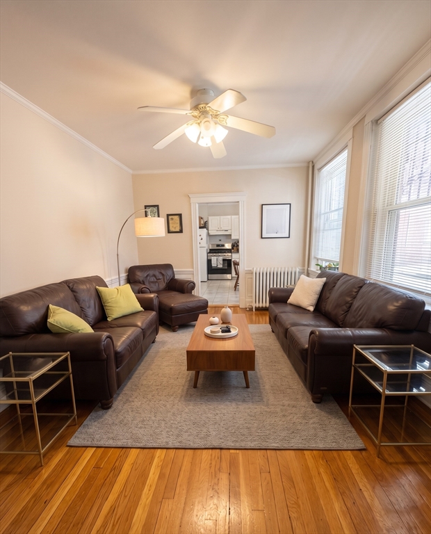 98 Strathmore Road, Unit 2 Boston, MA 02135 - Photo 1 of 11 a living room with furniture a flat screen tv and wooden floor