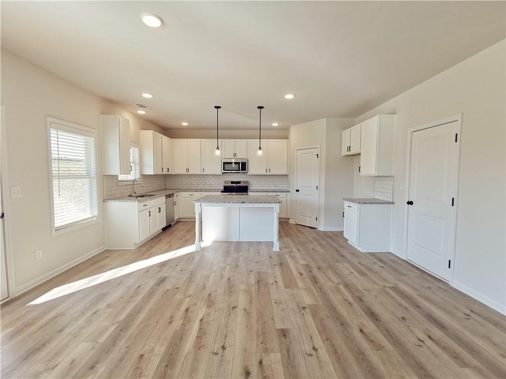 38 Longhorn Way Auburn, GA 30011 - Photo 13 of 36 a large kitchen with cabinets and wooden floor