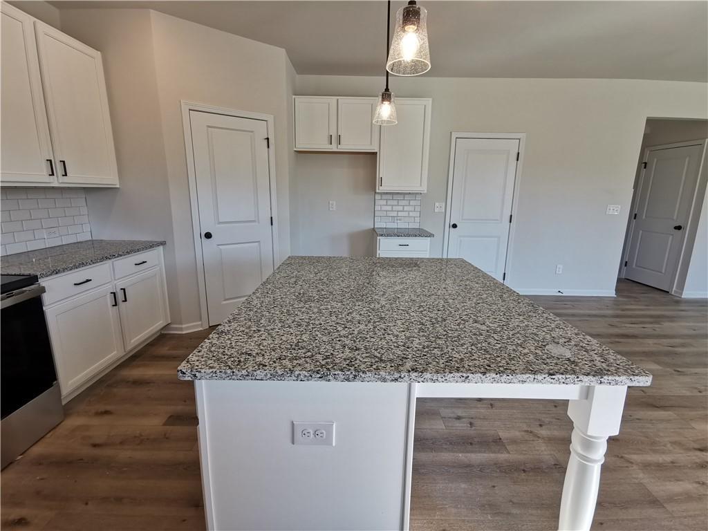 38 Longhorn Way Auburn, GA 30011 - Photo 16 of 36 a kitchen with kitchen island granite countertop white cabinets and granite counter tops