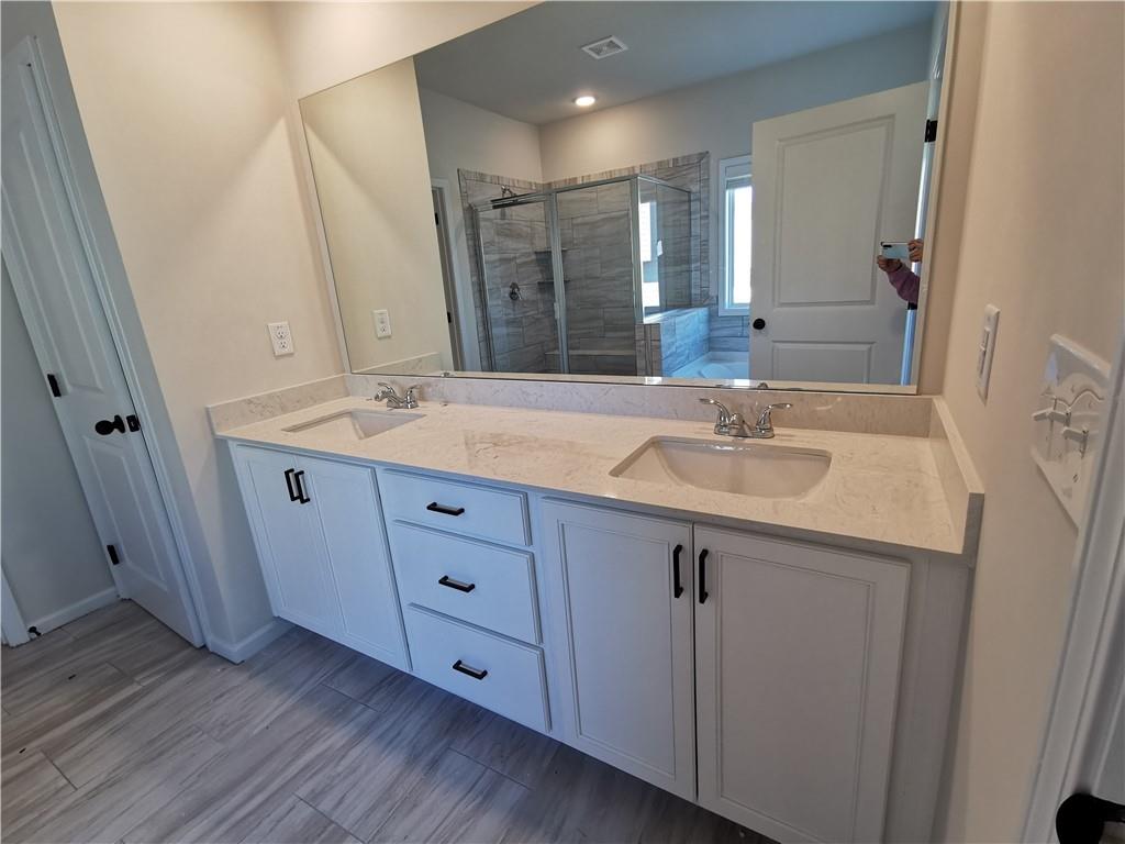 38 Longhorn Way Auburn, GA 30011 - Photo 26 of 36 a bathroom with a sink and a mirror