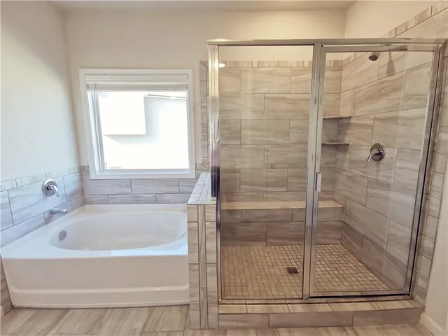 a white bath tub sitting next to a shower