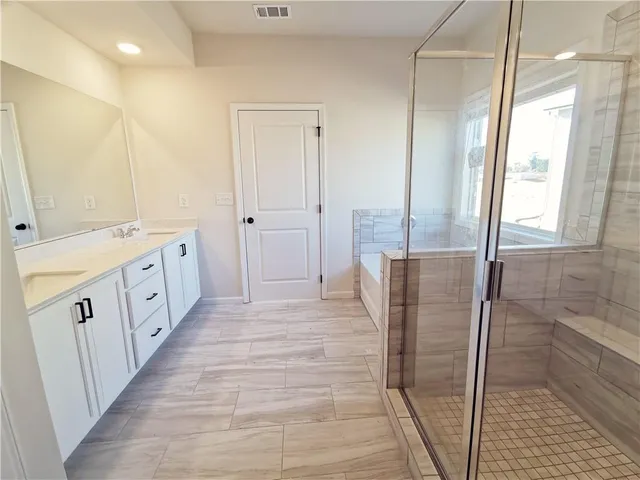 a bathroom with a double vanity sink and a mirror