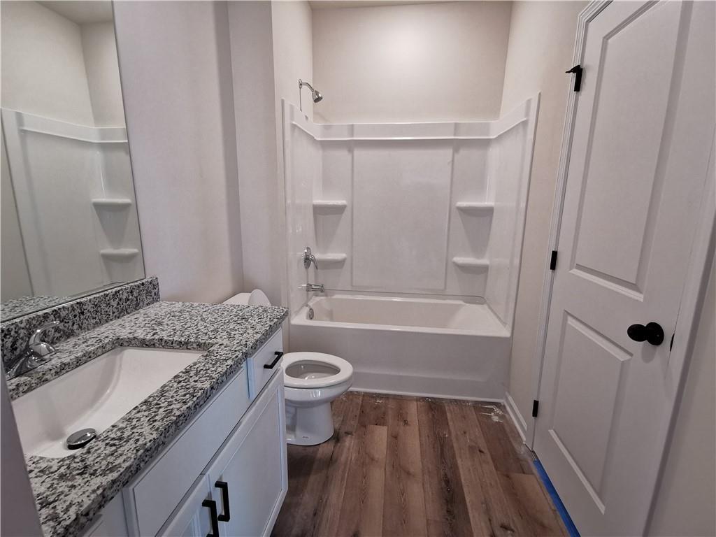 38 Longhorn Way Auburn, GA 30011 - Photo 8 of 36 a bathroom with a granite countertop sink toilet and shower