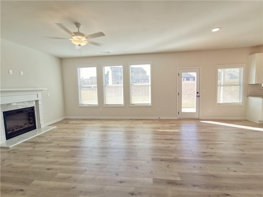 38 Longhorn Way Auburn, GA 30011 - Photo 10 of 36 a view of an empty room with window and wooden floor