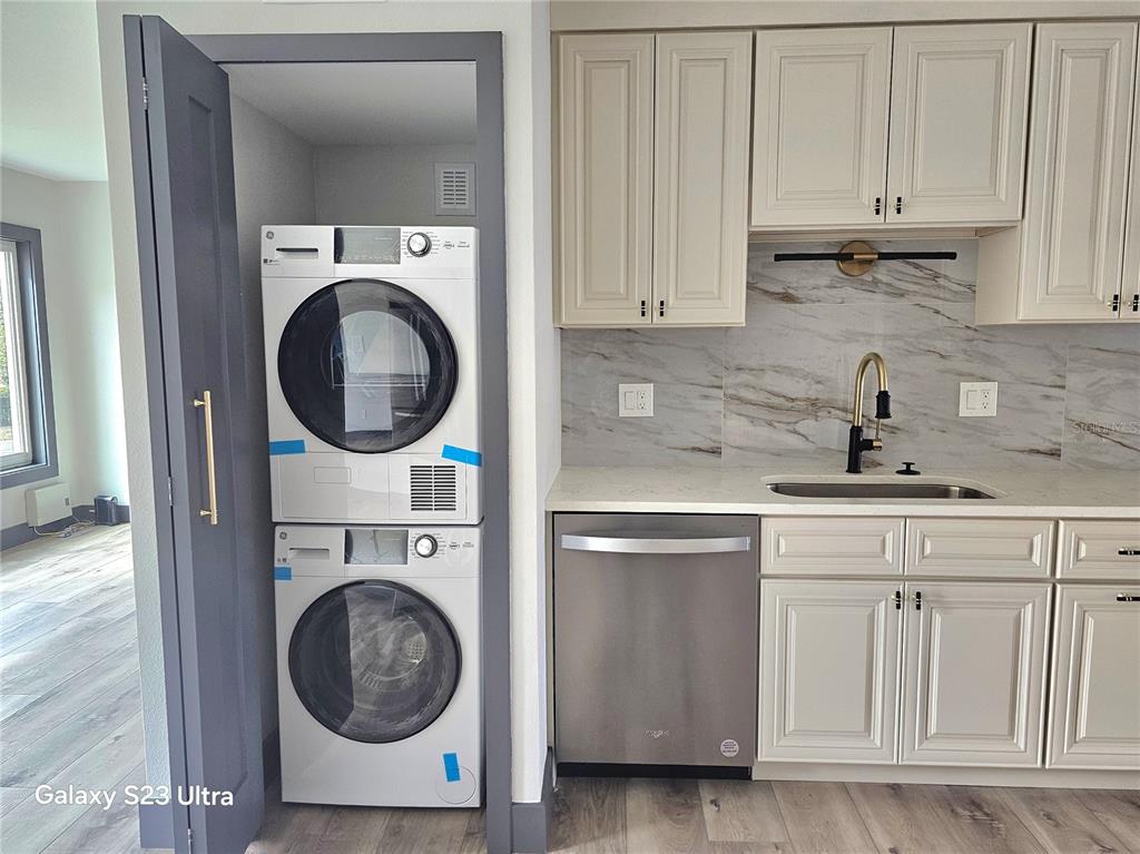 2435 Sumatran Way, Unit 35 Clearwater, FL 33763 - Photo 12 of 69 a kitchen with white cabinets and a sink