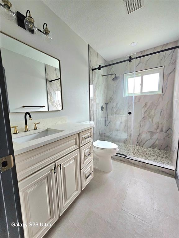2435 Sumatran Way, Unit 35 Clearwater, FL 33763 - Photo 15 of 69 a bathroom with a double vanity sink toilet and shower