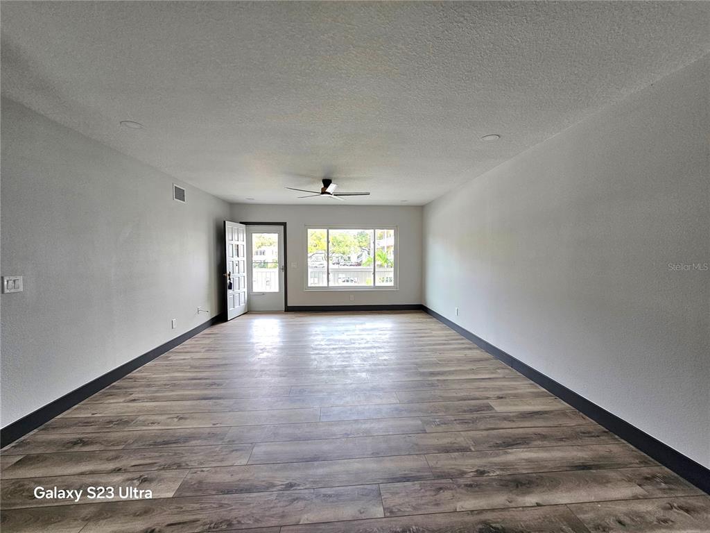 2435 Sumatran Way, Unit 35 Clearwater, FL 33763 - Photo 23 of 69 wooden floor in an empty room with a window