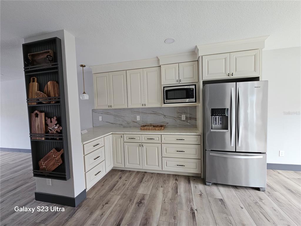 2435 Sumatran Way, Unit 35 Clearwater, FL 33763 - Photo 5 of 69 a kitchen with stainless steel appliances a refrigerator stove and microwave