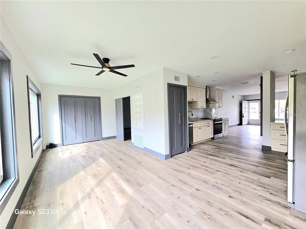 2435 Sumatran Way, Unit 35 Clearwater, FL 33763 - Photo 7 of 69 a view of a kitchen with wooden floor and a ceiling fan