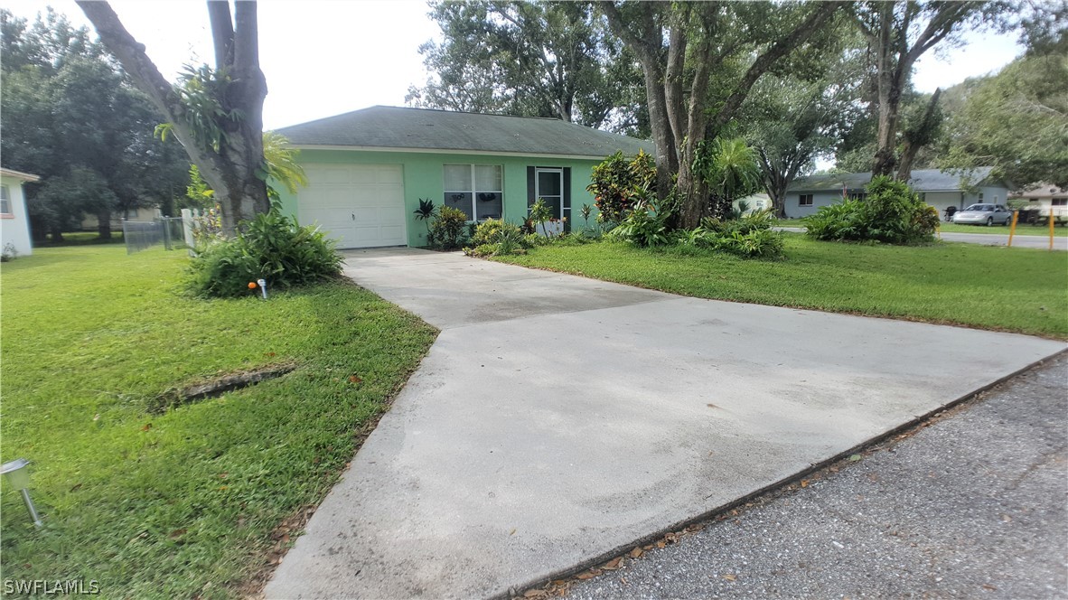 2332 Caladium Road Fort Myers, FL 33905 - Photo 2 of 17 a front view of a house with a yard