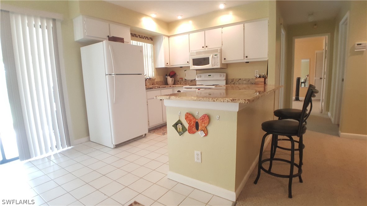 2332 Caladium Road Fort Myers, FL 33905 - Photo 6 of 17 a kitchen with refrigerator and window
