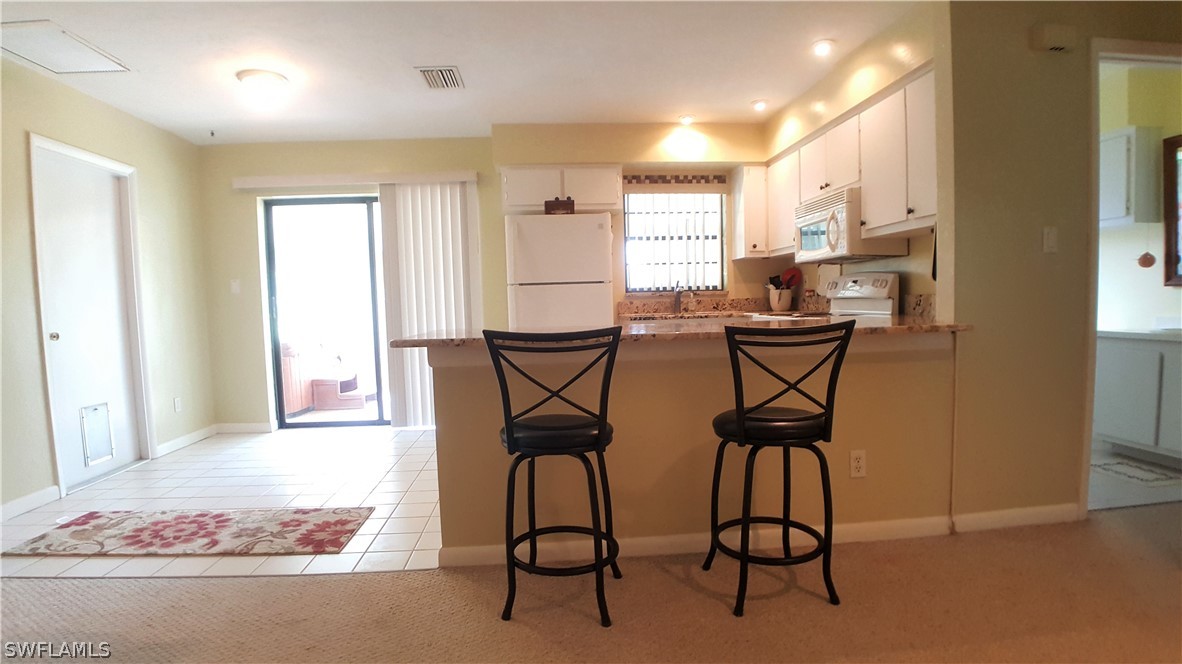 2332 Caladium Road Fort Myers, FL 33905 - Photo 8 of 17 a view of a dining room with furniture and window