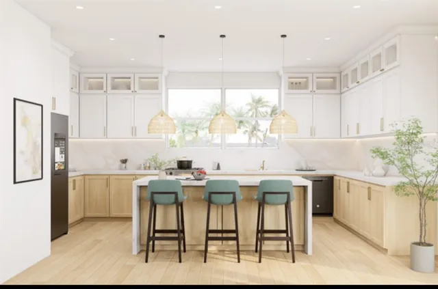 a kitchen with kitchen island a table and chairs in it