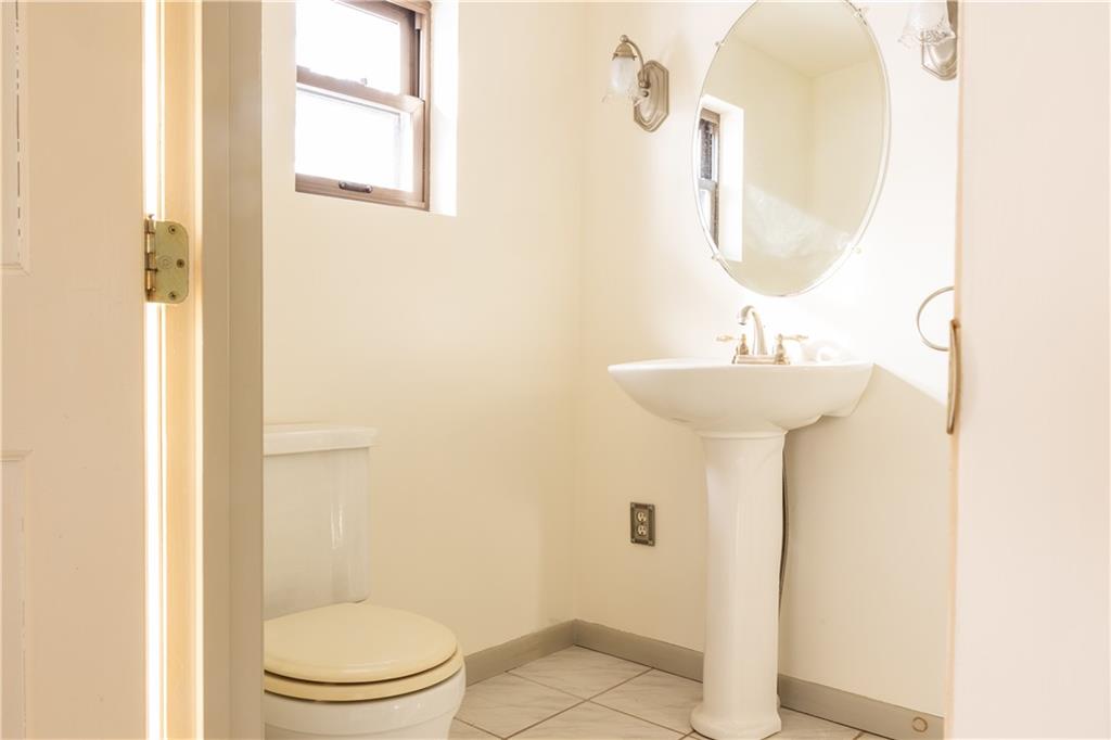 213 Unionville Road Butler, PA 16001 - Photo 19 of 38 a bathroom with a sink a mirror and a toilet