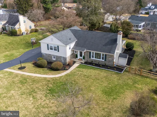 an aerial view of residential house with pool and yard