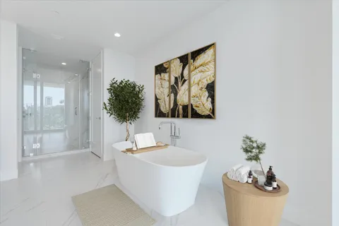 a bathroom with a granite countertop sink toilet a mirror and shower
