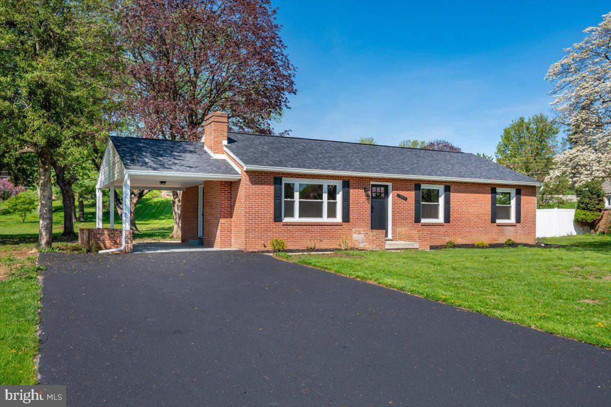 Charming brick home with lush surroundings.