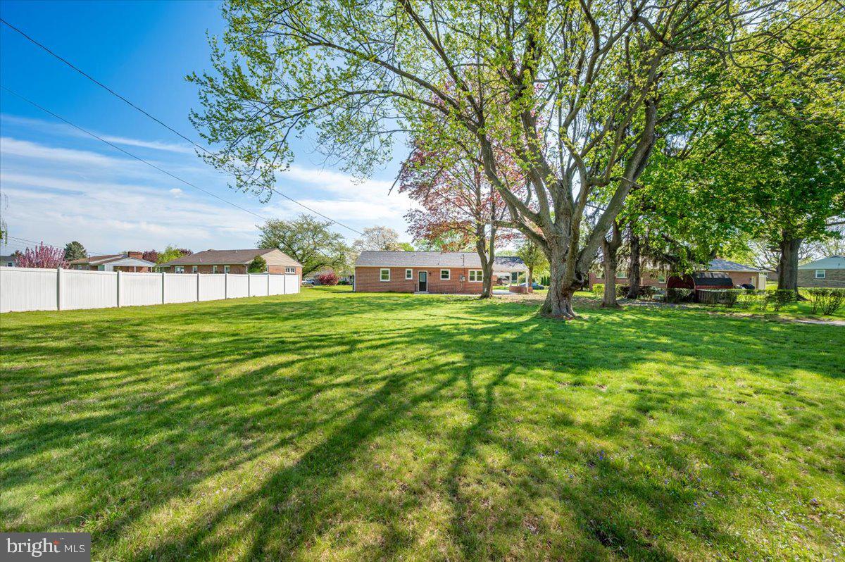 13616 Royal Road Hagerstown, MD 21742 - Photo 46 of 57 Spacious yard under a clear blue sky.